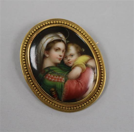 A yellow metal mounted oval plaque brooch, decorated with Virgin & Child, 41mm.